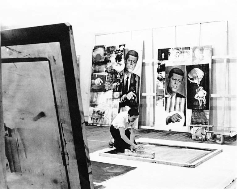 Rauschenberg working on the lower panel of Skyway (1964), Broadway studio, New York, 1964. Works in background are Buffalo II (1964) and Retroactive II (1963). Photo: Hans Namuth