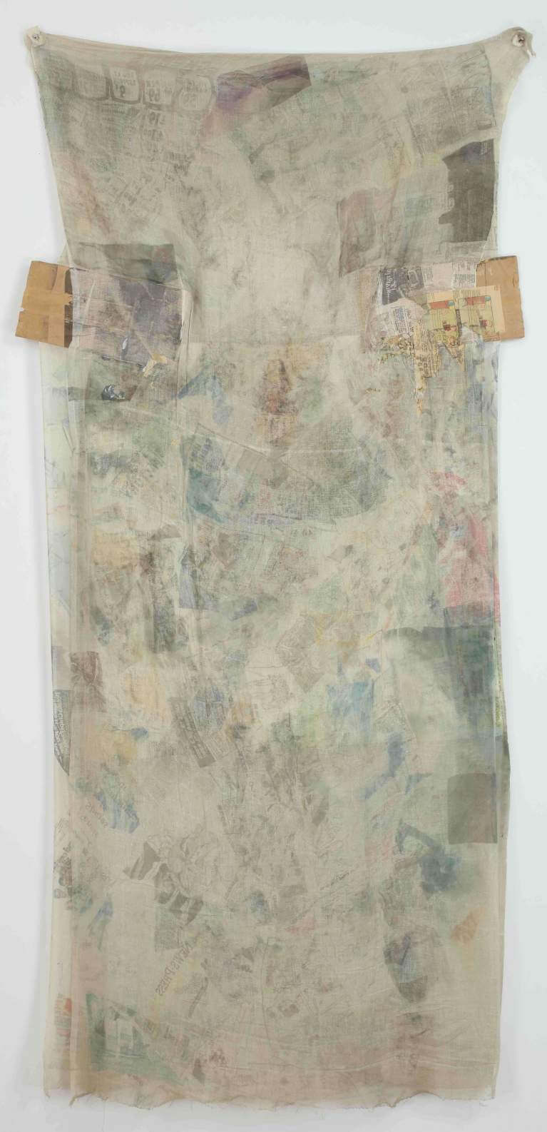 vertical fabric artwork with colored smudges. A small rectangular piece of cardboard sticks out on either side of the upper third